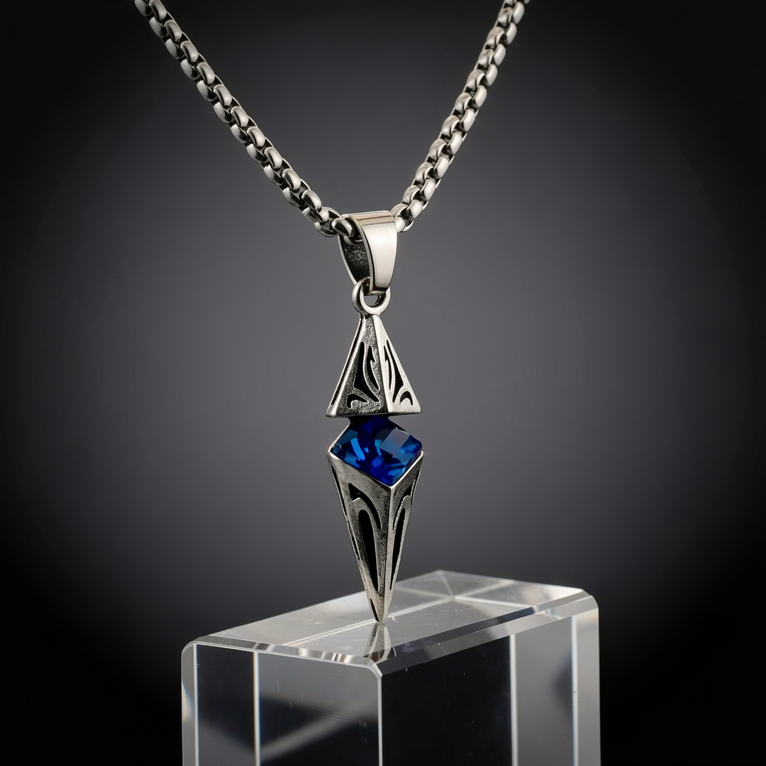 Axis Cobalt necklace presented on a clear plinth in a dark studio