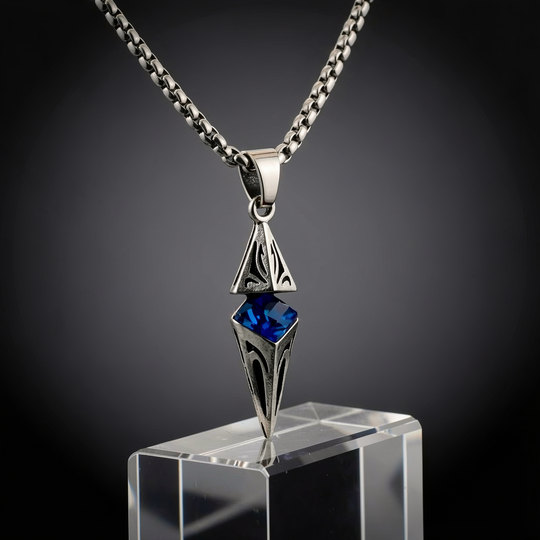 Axis Cobalt necklace presented on a clear plinth in a dark studio