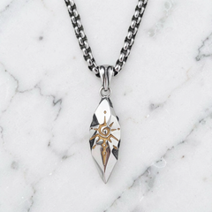 Sigil Quicksilver necklace arranged on white marble