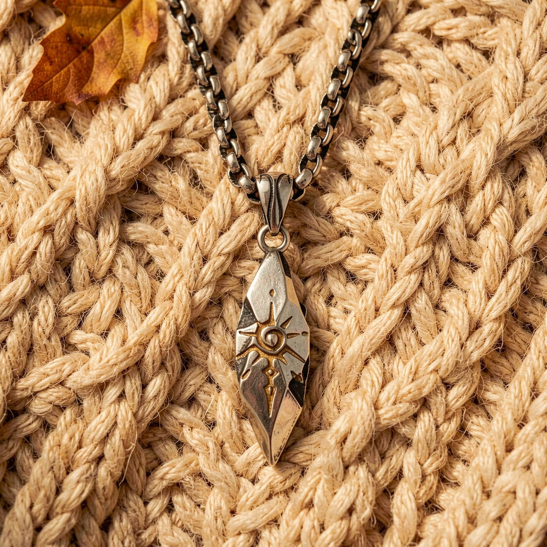 Sigil Quicksilver necklace arranged over a beige knit