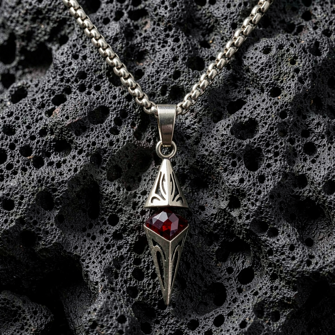 Axis Ruby necklace arranged on porous black stone