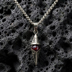 Axis Ruby necklace arranged on porous black stone