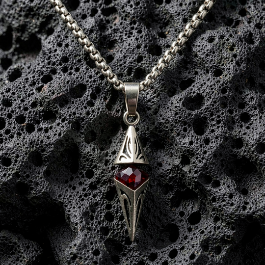 Axis Ruby necklace arranged on porous black stone