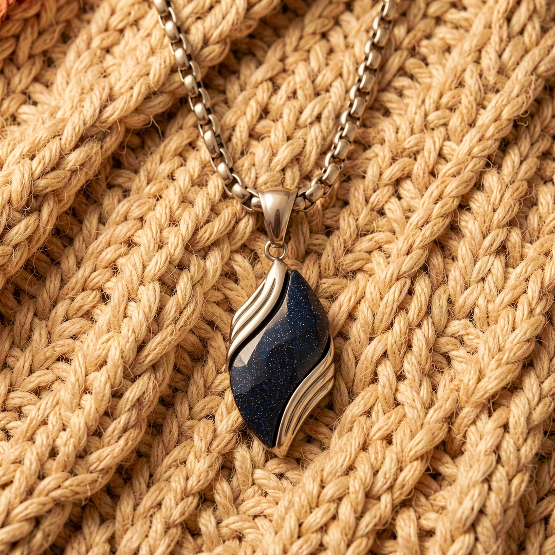 Nebula necklace arranged over a beige knit