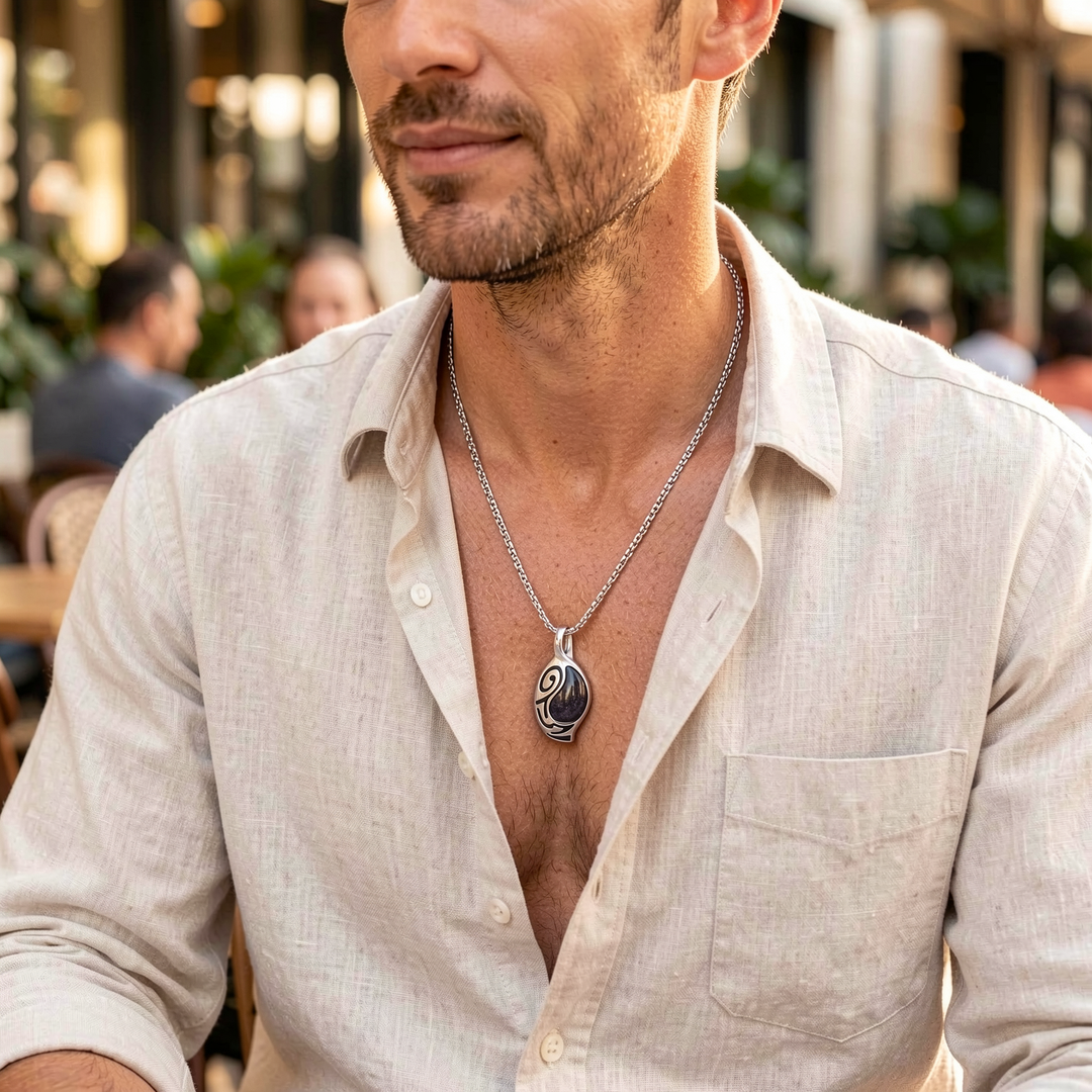 Vortex Cosmos necklace worn with a light linen shirt at a cafe