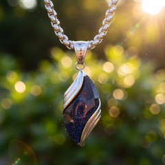 Nebula pendant suspended outdoors in warm backlight