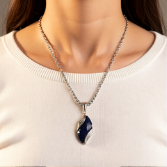 Nebula necklace worn over a white top
