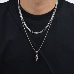 Shard necklace layered with a thicker silver chain over a black shirt