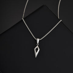 Shard silver pendant and chain arranged diagonally on a black surface