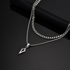 Shard necklace layered with a thicker silver chain on black