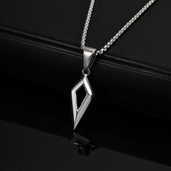 Shard silver open diamond pendant resting on a black reflective surface