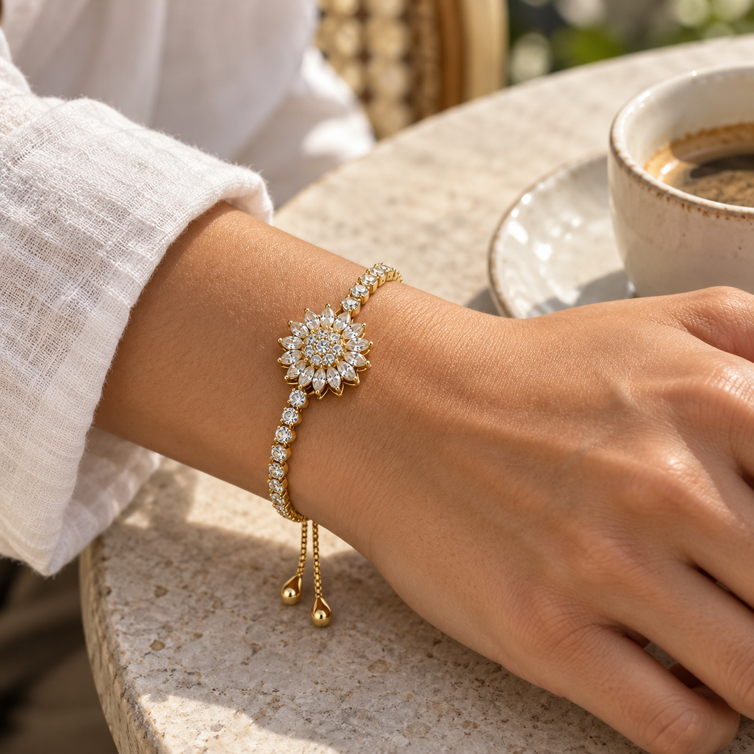 Blossom Gold bracelet worn with an ivory linen sleeve at a sunlit café