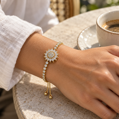 Blossom Gold bracelet worn with an ivory linen sleeve at a sunlit café
