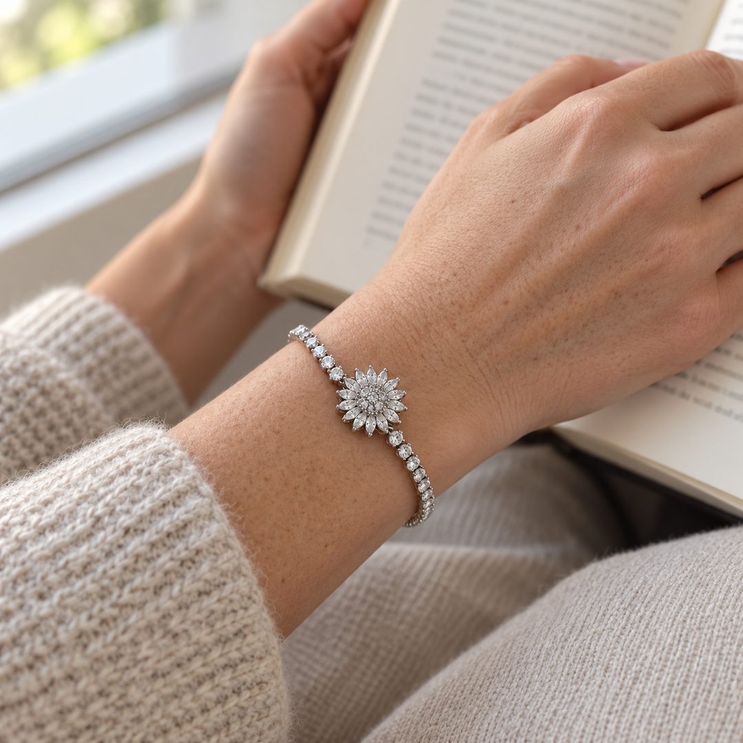 Blossom Silver bracelet worn with an oatmeal knit beside a window