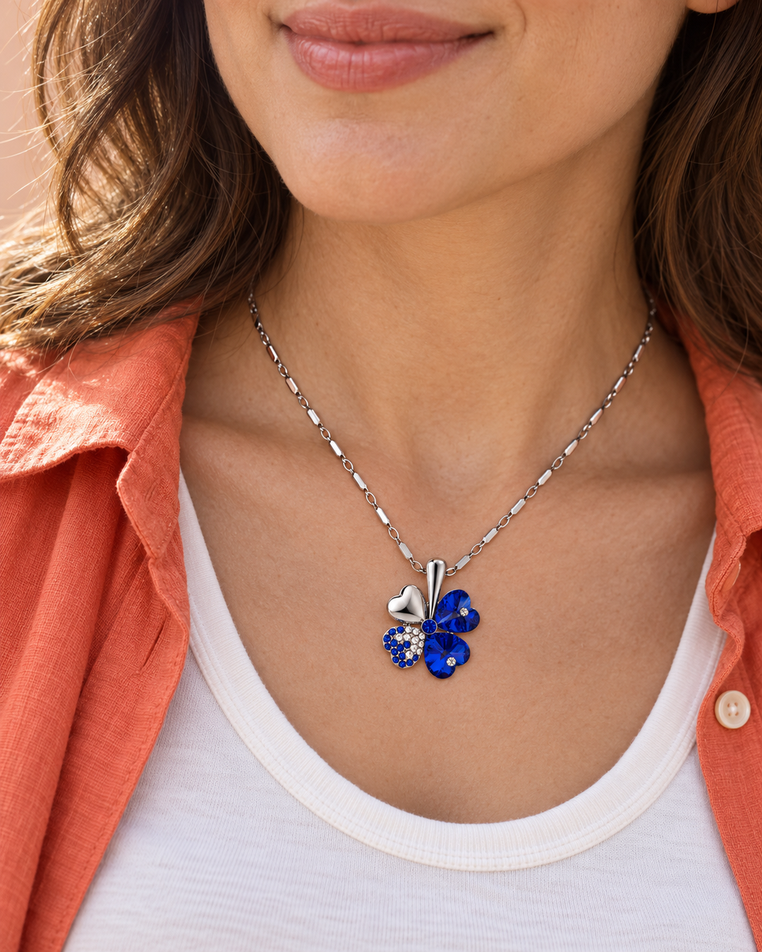 Clover necklace in Cobalt worn with an ivory top and coral shirt