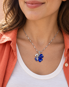 Clover necklace in Cobalt worn with an ivory top and coral shirt
