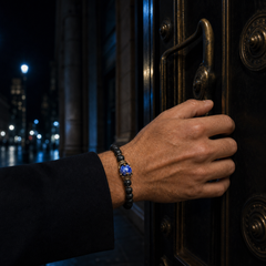 ZAFT CREST Tempest bracelet worn at a brass door under cobalt night light