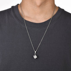 Cube Silver necklace worn over a black crew-neck shirt
