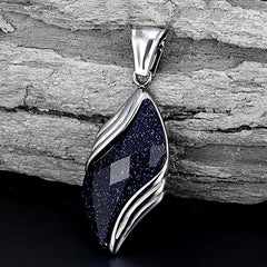 Nebula pendant resting against pale textured stone