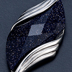 Macro view of the Nebula faceted blue glitter stone and silver frame