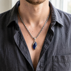 Nebula necklace worn with a charcoal open-collar shirt