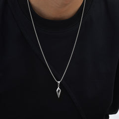 Shard silver open diamond necklace worn over a black shirt