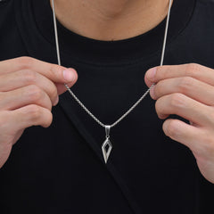 Shard necklace held at the chain to show pendant scale