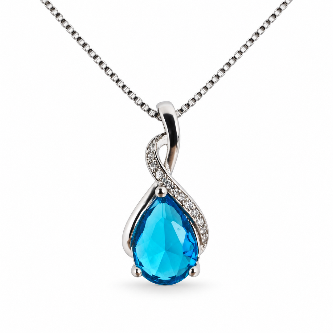 Drop Sky light blue necklace, showing the faceted pear-shaped centre and flowing silver setting on white