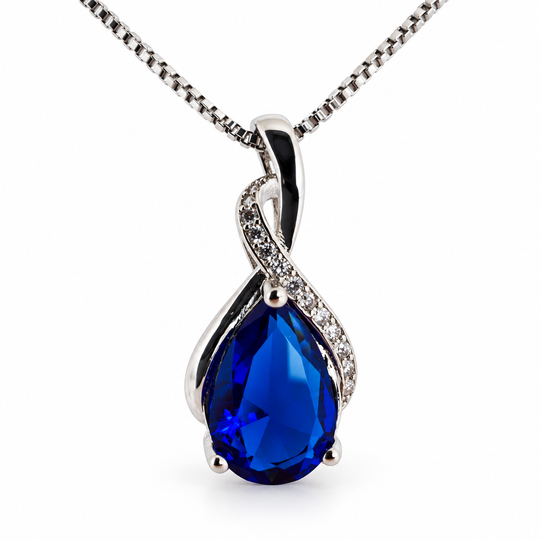Drop cobalt necklace, showing the faceted pear-shaped centre and flowing silver setting on white