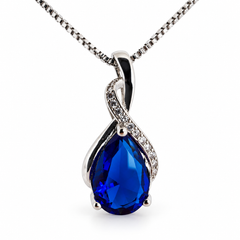 Drop cobalt necklace, showing the faceted pear-shaped centre and flowing silver setting on white