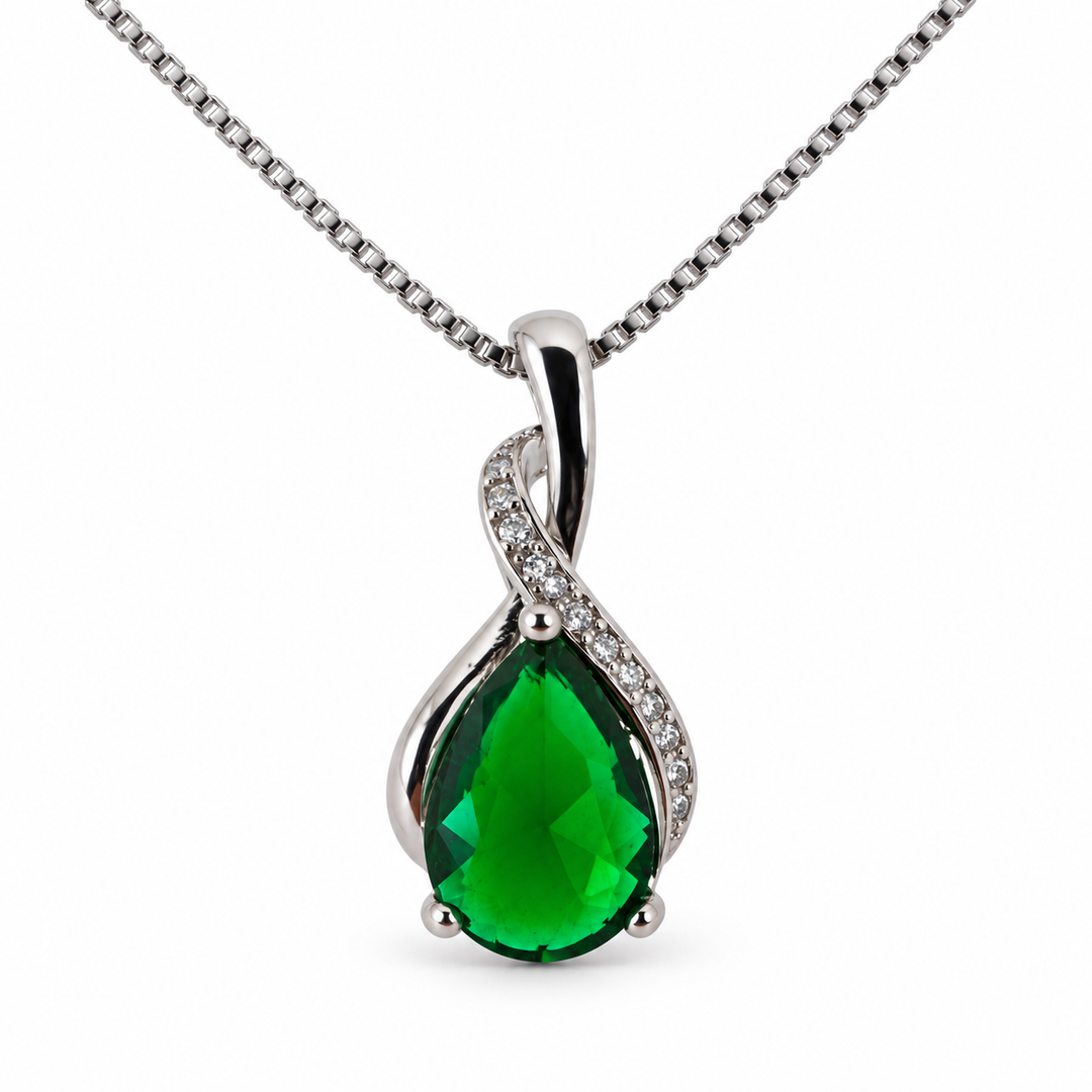 Drop forest necklace, showing the faceted pear-shaped centre and flowing silver setting on white