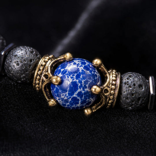 Crest Tempest blue centre stone and antique-gold setting macro detail