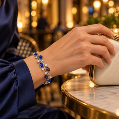 Eden in Cobalt with a silver-tone finish, worn with navy satin and a clutch.