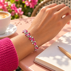 Eden in Rose with a silver-tone finish, worn with raspberry knitwear.