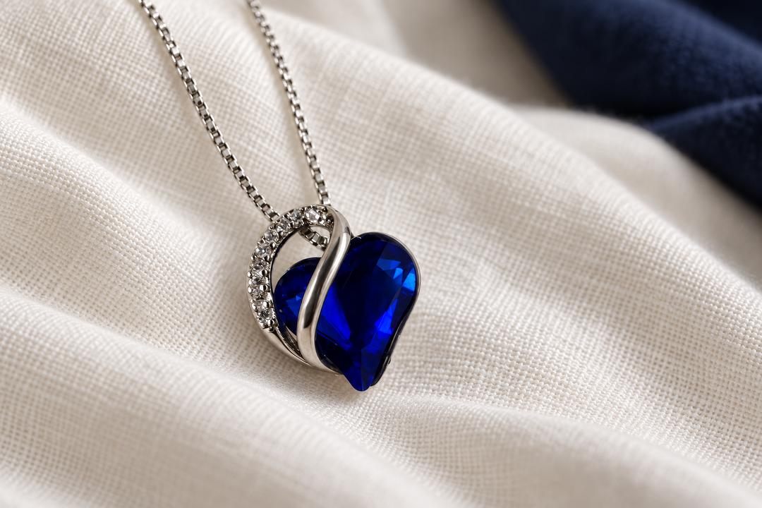 Embrace Cobalt heart necklace styled on ivory linen