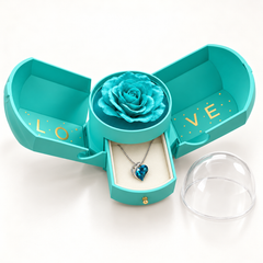 Embrace azure necklace in its matching Rose Box, with the sides open, drawer extended and removable clear dome alongside.