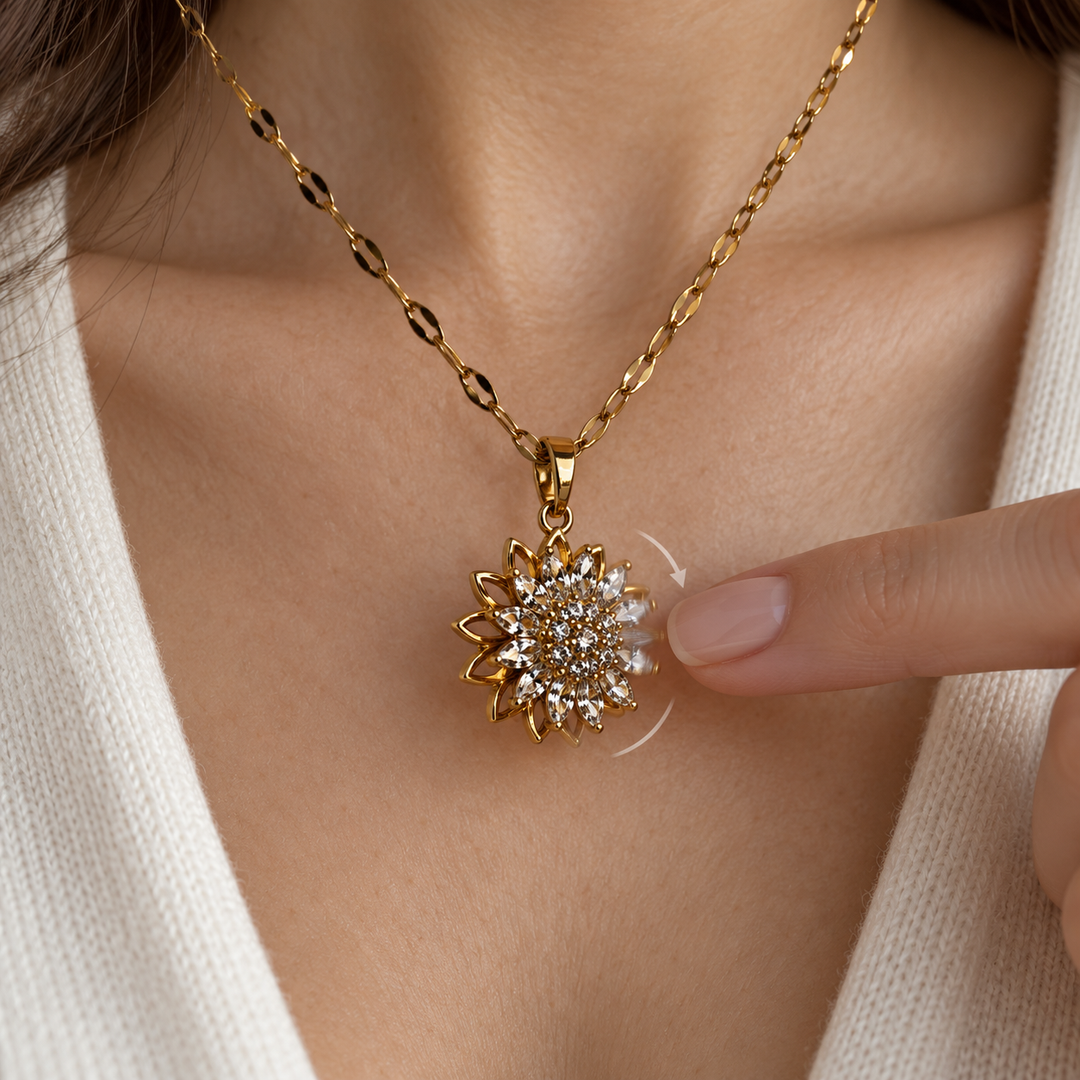 A fingertip gently turns Flora Gold's upper flower; curved arrows illustrate the rotating face