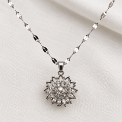 Flora Silver pendant and chain in close detail on ivory linen