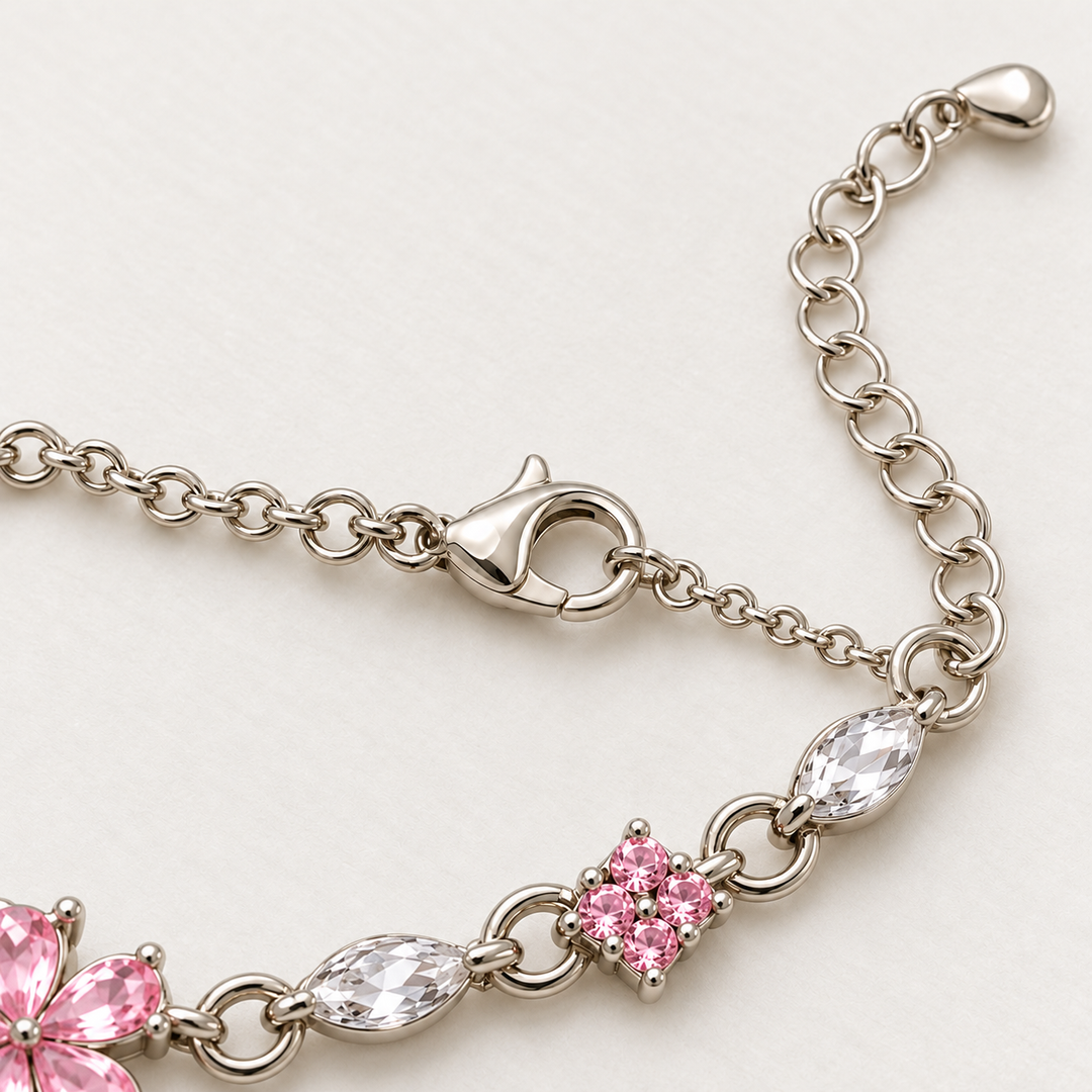 Close-up of Floret's lobster clasp, extension chain and teardrop end tab on ivory