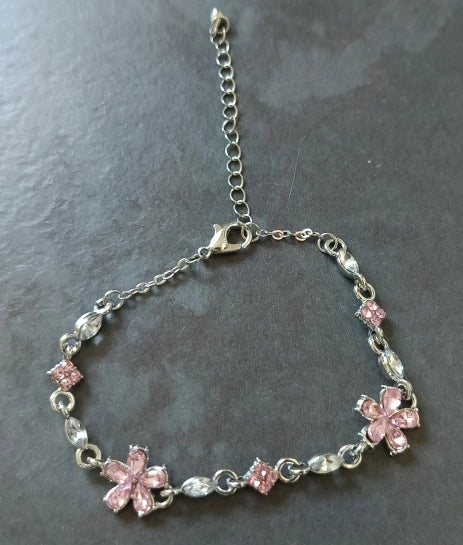 Genuine photo of one Floret bracelet, showing its two pink flowers, single strand, lobster clasp and extension