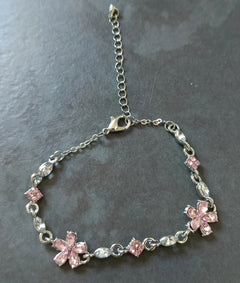 Genuine photo of one Floret bracelet, showing its two pink flowers, single strand, lobster clasp and extension
