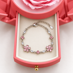 Close-up of Floret's two pink flowers, clear stones and clasp inside the pink Rose Box drawer