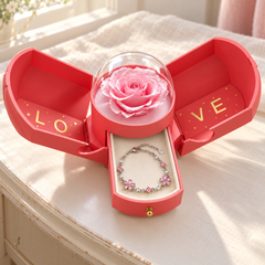 Floret in the open pink Rose Box on an ivory dressing table, with its clear dome over the rose
