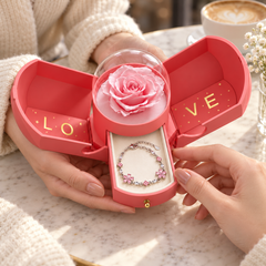 Hands sharing the open pink Rose Box, with one Floret bracelet in the jewellery drawer
