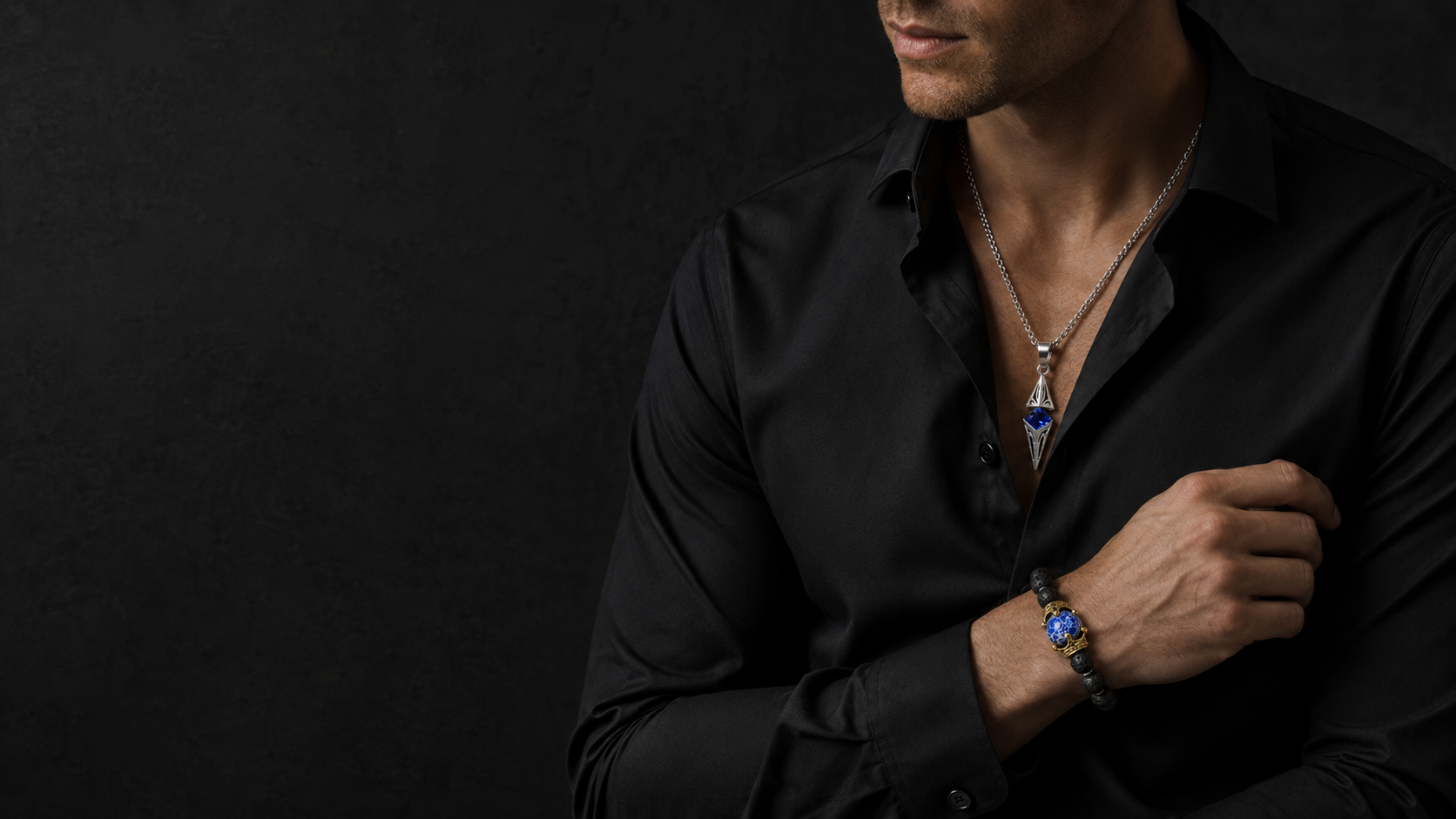 ZAFT Axis necklace and Crest bracelet styled on a man against dark stone