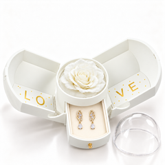 Iris Clear Gold earrings, one pair in the open white Rose Box drawer, with matching rose and clear dome alongside