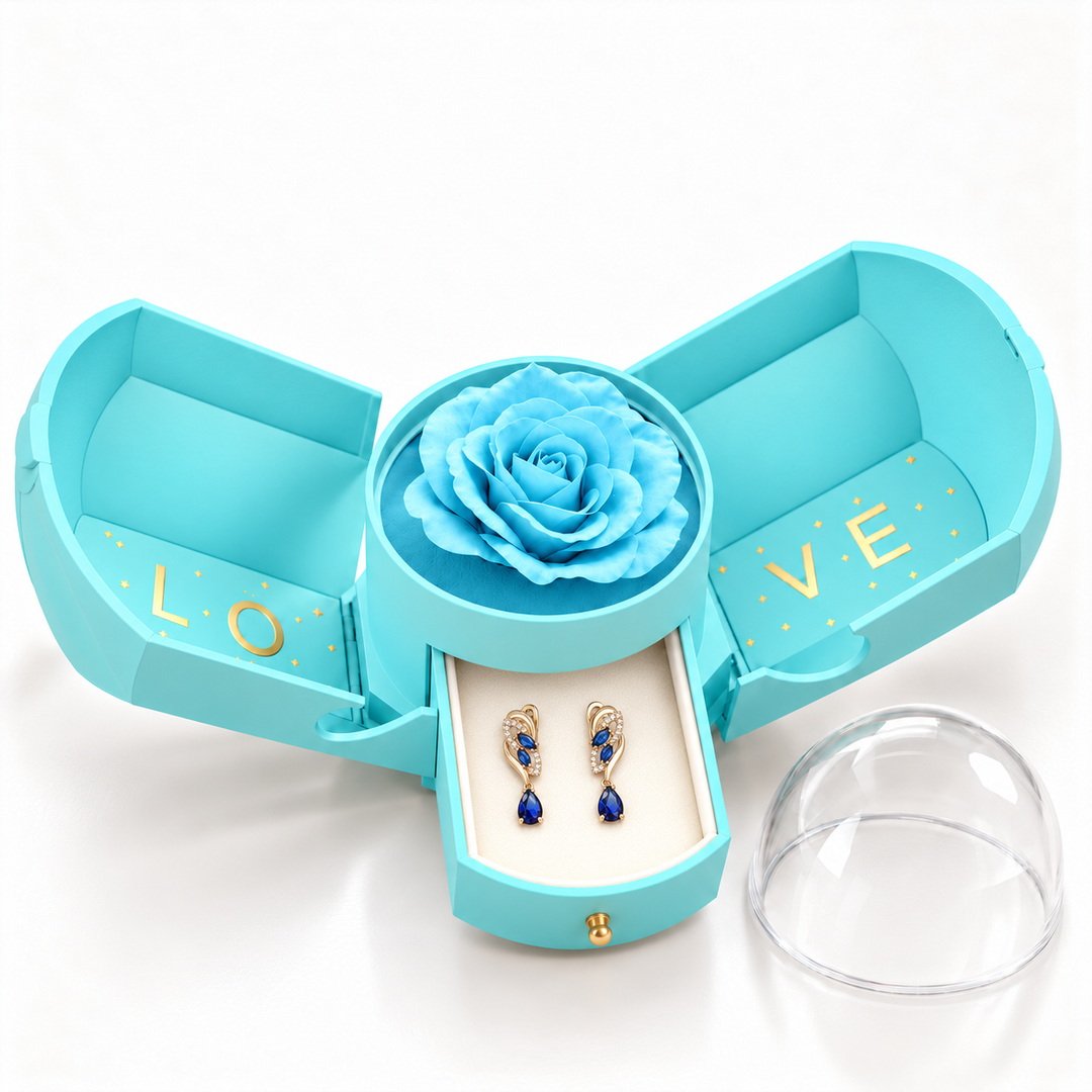 Iris Cobalt Gold earrings, one pair in the open light blue Rose Box drawer, with matching rose and clear dome alongside