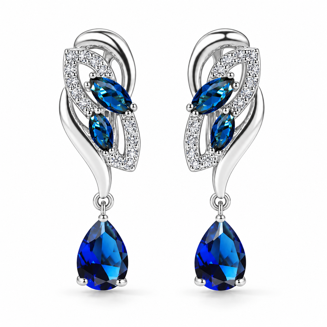 Iris Drop Earrings in Cobalt, a matching pair with a silver leaf-inspired setting and blue pear-shaped drops on white
