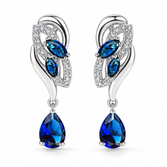 Iris Drop Earrings in Cobalt, a matching pair with a silver leaf-inspired setting and blue pear-shaped drops on white