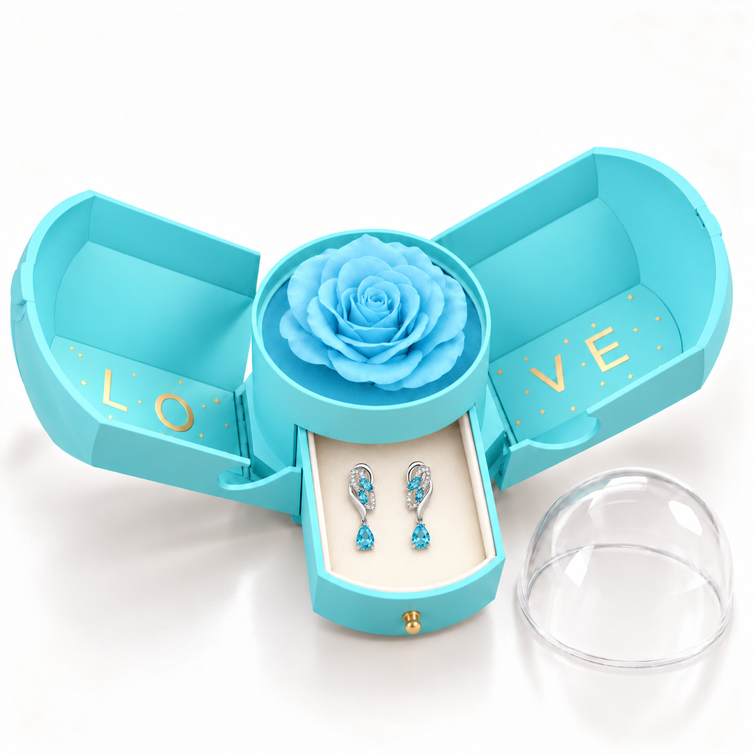 Iris Glacier Silver earrings, one pair in the open light blue Rose Box drawer, with the matching rose and clear dome alongside